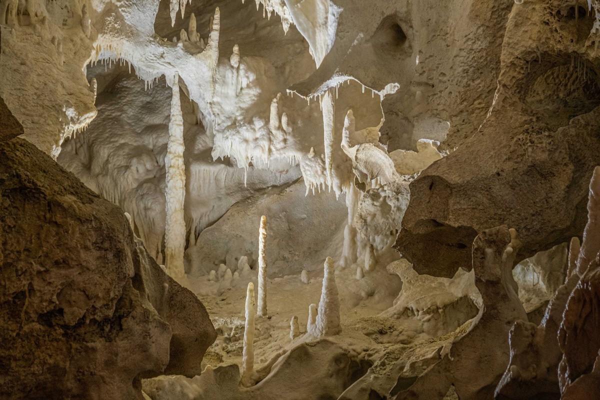 Limestone cave interior with stalactites and stalagmites, similar to Hato Caves Curaçao